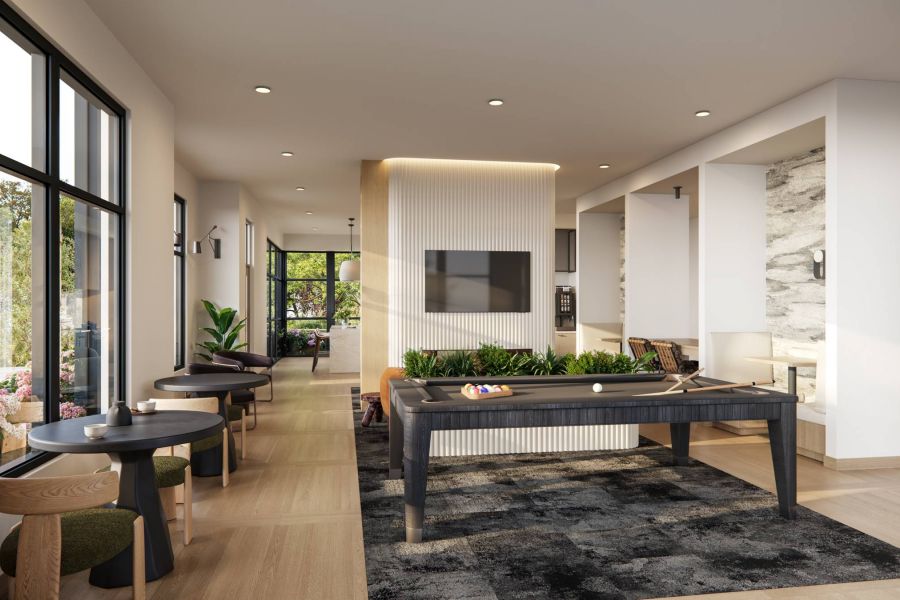 Royce Townhomes Modern lounge with pool table, TV, seating areas, large windows, plants, and light wood flooring.