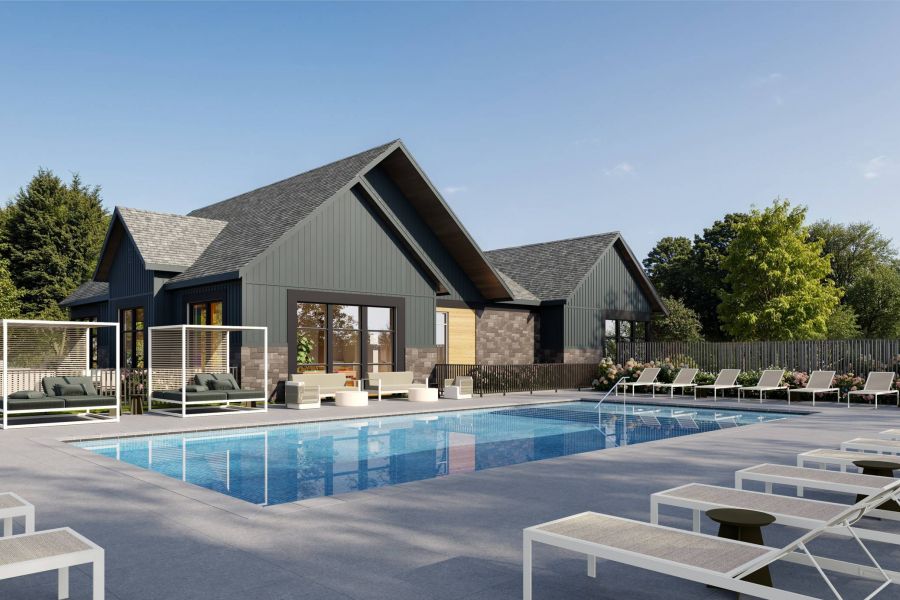 Royce Townhomes Modern outdoor pool with lounge chairs, shaded cabanas, and a contemporary clubhouse surrounded by trees under a clear sky.